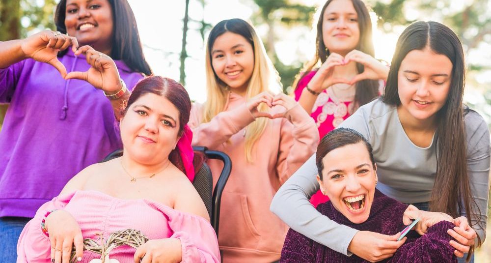 International womens day Inspire Inclusion multiethnic group do love heart with hands. Wheelchair-wheelofhope